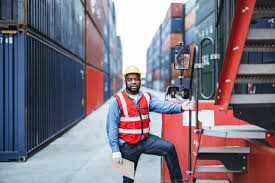 Cargo Agent Jobs in Saudi: A professional worker loads and inspects cargo containers.
